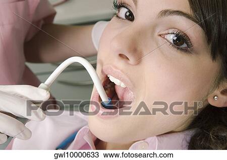 Dentist cleaning woman's teeth View Large Photo Image Stock Image - Dentist cleaning woman's teeth. Fotosearch