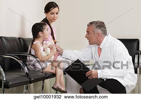 Dentist discussing with his patient View Large Photo Image Stock Image - Dentist discussing with his patient. Fotosearch