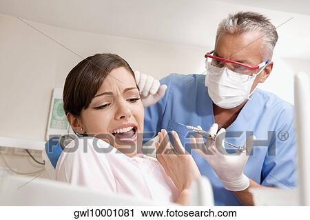 Dentist injecting a patient View Large Photo Image Stock Image - Dentist injecting a patient. Fotosearch