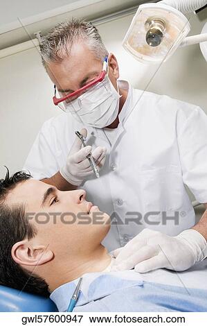 Dentist injecting a patient View Large Photo Image Stock Photo - Dentist injecting a patient. Fotosearch