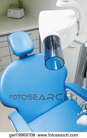 Stock Photo - Dentist's chair with an X-Ray machine in an examination room. Fotosearch
