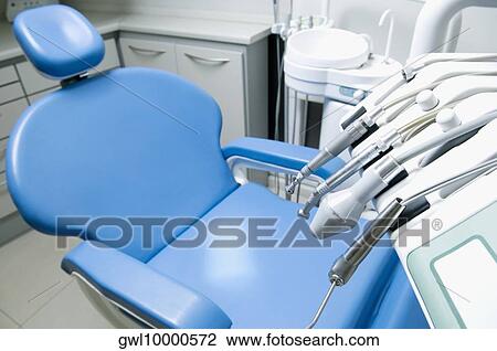 Stock Image - Dentist's chair with instruments in an examination room. Fotosearch