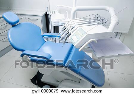 Dentist's chair with instruments in an examination room View Large Photo Image Stock Photo - Dentist's chair with instruments in an examination room. Fotosearch