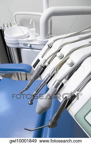 Dentist's chair with instruments in an examination room View Large Photo Image Stock Photo - Dentist's chair with instruments in an examination room. Fotosearch