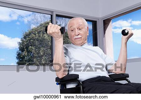 Stock Image - Disabled man exercising with dumbbells. Fotosearch