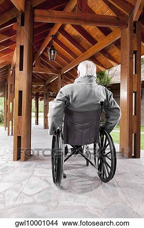 Disabled man sitting in a wheelchair View Large Photo Image Picture - Disabled man sitting in a wheelchair. Fotosearch