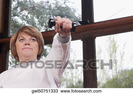 Disabled woman exercising with dumbbells View Large Photo Image Stock Image - Disabled woman exercising with dumbbells. Fotosearch