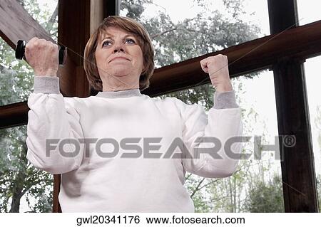 Disabled woman exercising with dumbbells View Large Photo Image Stock Photograph - Disabled woman exercising with dumbbells. Fotosearch