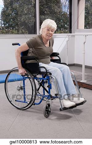 Disabled woman sitting in a wheelchair View Large Photo Image Stock Image - Disabled woman sitting in a wheelchair. Fotosearch