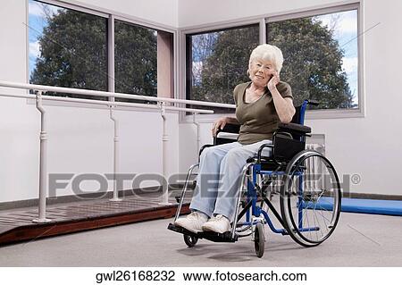 Disabled woman sitting in a wheelchair and talking on a mobile phone View Large Photo Image Stock Image - Disabled woman sitting in a wheelchair and talking on a mobile phone. Fotosearch