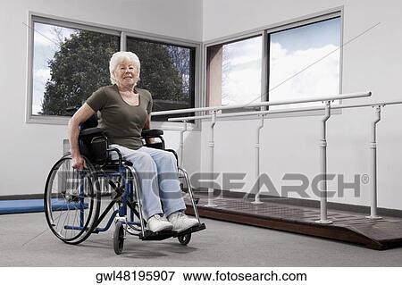 Disabled woman sitting in a wheelchair View Large Photo Image Stock Photo - Disabled woman sitting in a wheelchair. Fotosearch