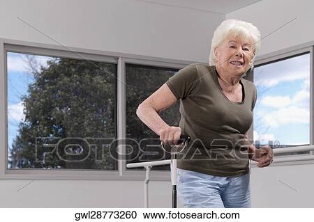 Disabled woman walking with a cane View Large Photo Image Stock Image - Disabled woman walking with a cane. Fotosearch