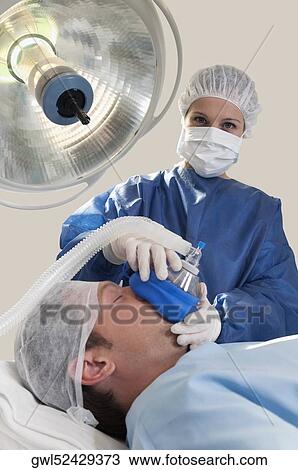Doctor anaesthetizing a patient in an operating room View Large Photo Image Stock Image - Doctor anaesthetizing a patient in an operating room. Fotosearch