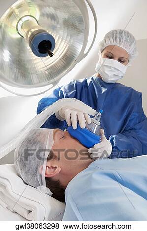 Doctor anaesthetizing a patient in an operating room View Large Photo Image Stock Photo - Doctor anaesthetizing a patient in an operating room. Fotosearch