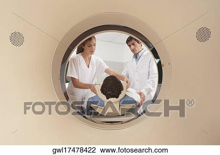Doctor and nurse preparing a patient for MRI scan View Large Photo Image Stock Image - Doctor and nurse preparing a patient for MRI scan. Fotosearch