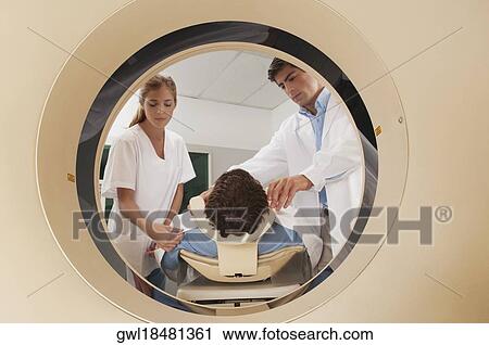 Doctor and nurse preparing a patient for MRI scan View Large Photo Image Stock Image - Doctor and nurse preparing a patient for MRI scan. Fotosearch