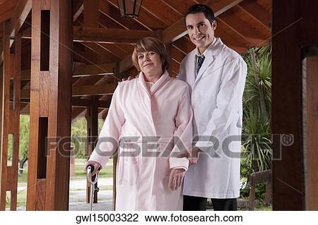 Doctor assisting a patient in walking in a rehabilitation centre View Large Photo Image Stock Image - Doctor assisting a patient in walking in a rehabilitation centre. Fotosearch