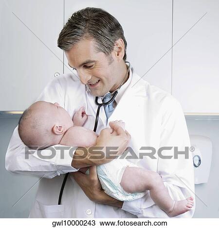 Doctor carrying a newborn baby View Large Photo Image Stock Image - Doctor carrying a newborn baby. Fotosearch