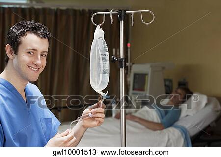 Doctor checking a saline drip View Large Photo Image Stock Image - Doctor checking a saline drip. Fotosearch