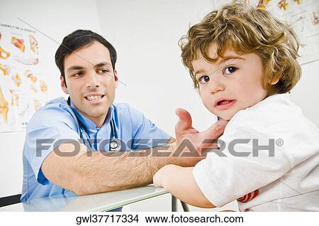 Doctor examining a baby boy View Large Photo Image Picture - Doctor examining a baby boy. Fotosearch