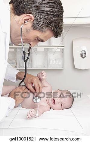 Doctor examining a newborn baby View Large Photo Image Stock Image - Doctor examining a newborn baby. Fotosearch