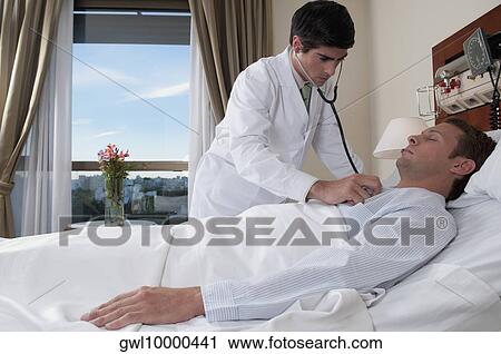 Doctor examining a patient in a hospital View Large Photo Image Stock Image - Doctor examining a patient in a hospital. Fotosearch