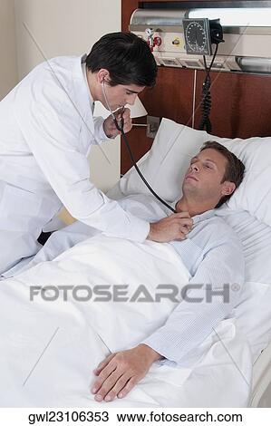 Doctor examining a patient in a hospital View Large Photo Image Stock Image - Doctor examining a patient in a hospital. Fotosearch