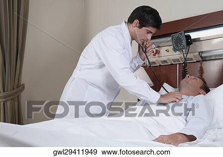 Doctor examining a patient in a hospital View Large Photo Image Stock Photo - Doctor examining a patient in a hospital. Fotosearch