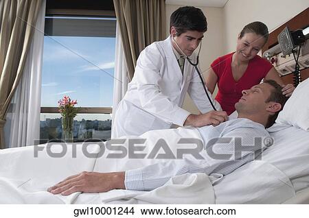 Doctor examining a patient View Large Photo Image Picture - Doctor examining a patient. Fotosearch