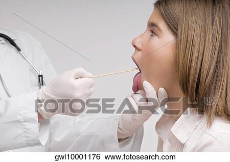 Doctor examining a patient View Large Photo Image Stock Photograph - Doctor examining a patient. Fotosearch