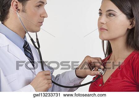 Doctor examining a woman View Large Photo Image Stock Image - Doctor examining a woman. Fotosearch
