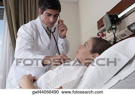 Doctor examining a woman View Large Photo Image Stock Image - Doctor examining a woman. Fotosearch