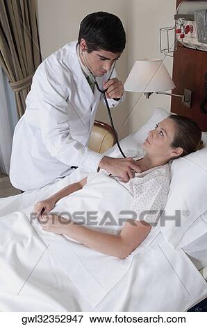Doctor examining a woman View Large Photo Image Stock Photo - Doctor examining a woman. Fotosearch