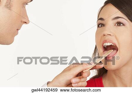 Doctor examining a woman View Large Photo Image Stock Photo - Doctor examining a woman. Fotosearch