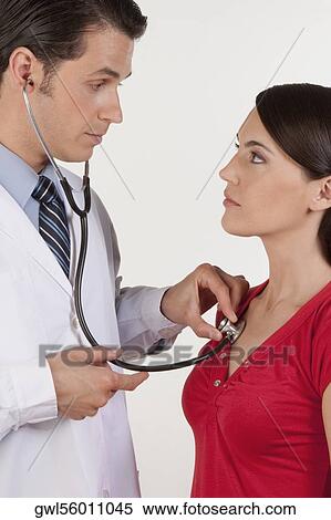 Stock Photography - Doctor examining a woman. Fotosearch