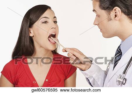 Doctor examining a woman View Large Photo Image Stock Photography - Doctor examining a woman. Fotosearch