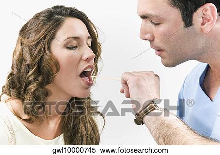 Doctor examining a woman's throat View Large Photo Image Stock Photography - Doctor examining a woman's throat. Fotosearch