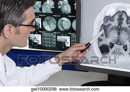 Doctor examining MRI report View Large Photo Image Stock Photo - Doctor examining MRI report. Fotosearch
