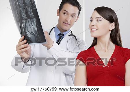 Doctor explaining x-ray report to a patient View Large Photo Image Stock Photo - Doctor explaining x-ray report to a patient. Fotosearch