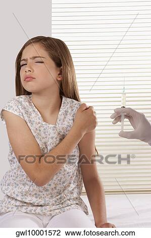 Doctor giving an injecting to a girl View Large Photo Image Stock Image - Doctor giving an injecting to a girl. Fotosearch