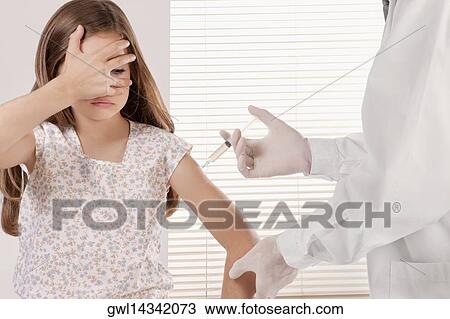Doctor giving an injecting to a girl View Large Photo Image Stock Image - Doctor giving an injecting to a girl. Fotosearch