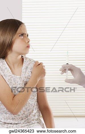 Doctor giving an injecting to a girl View Large Photo Image Stock Image - Doctor giving an injecting to a girl. Fotosearch