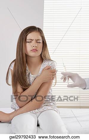 Doctor giving an injecting to a girl View Large Photo Image Stock Image - Doctor giving an injecting to a girl. Fotosearch