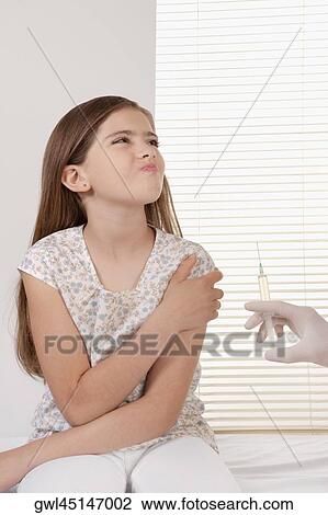 Doctor giving an injecting to a girl View Large Photo Image Stock Image - Doctor giving an injecting to a girl. Fotosearch