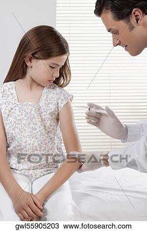 Doctor giving an injecting to a girl View Large Photo Image Stock Image - Doctor giving an injecting to a girl. Fotosearch