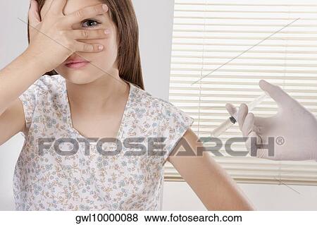 Doctor giving an injecting to a girl View Large Photo Image Stock Photo - Doctor giving an injecting to a girl. Fotosearch