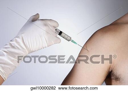 Doctor giving injection to a patient View Large Photo Image Stock Image - Doctor giving injection to a patient. Fotosearch