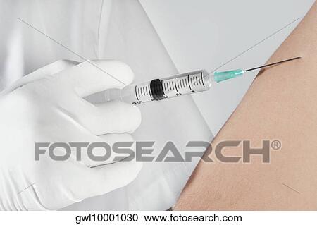 Doctor giving injection to a patient View Large Photo Image Stock Image - Doctor giving injection to a patient. Fotosearch