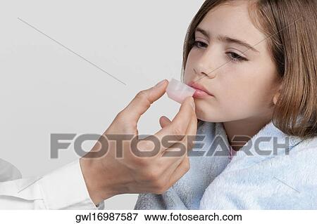Doctor giving medicine to a girl View Large Photo Image Stock Photo - Doctor giving medicine to a girl. Fotosearch