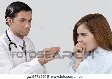 Doctor giving medicine to a girl View Large Photo Image Stock Photograph - Doctor giving medicine to a girl. Fotosearch